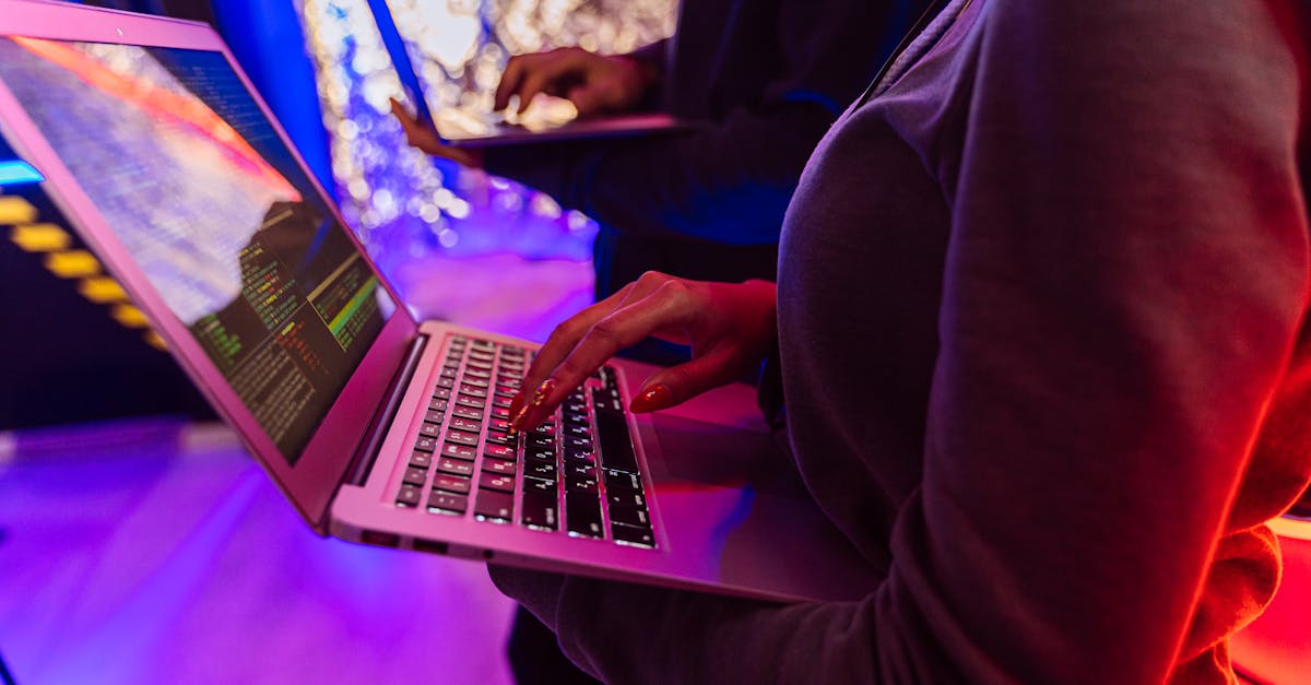 Person in Black Long Sleeve Shirt Using Macbook Pro